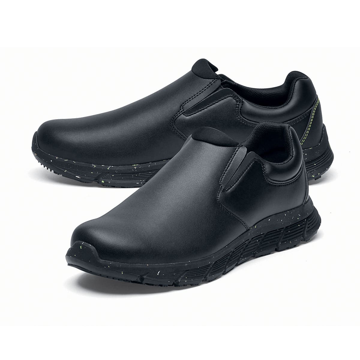 The Shoes for Crews Cater Eco Men's Black is a sustainable, slip-resistant safety shoe, pair seen from the left side, emphasised on the tip of the left shoe.