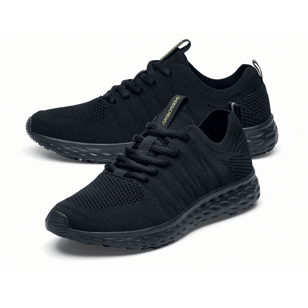 The Everlight™ Everlight Eco Women's Black from Shoes For Crews are lightweight and breathable slip-resistant trainers made from recycled materials, pair seen from the left side, emphasised on the tip of the left shoe.