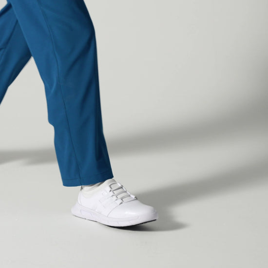 The Karina White by Lila from Shoes For Crews are black slip-resistant trainers that are lightweight and have Flex Tread technology, product video.